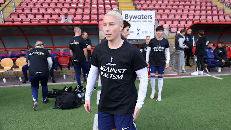 Pelaajalla on päällään lämmittelyasu, jossa lukee "Spurs against racism".