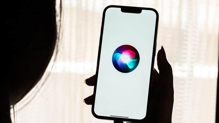 Henkilö käyttää Siri-avustajaa iPhonellaan.