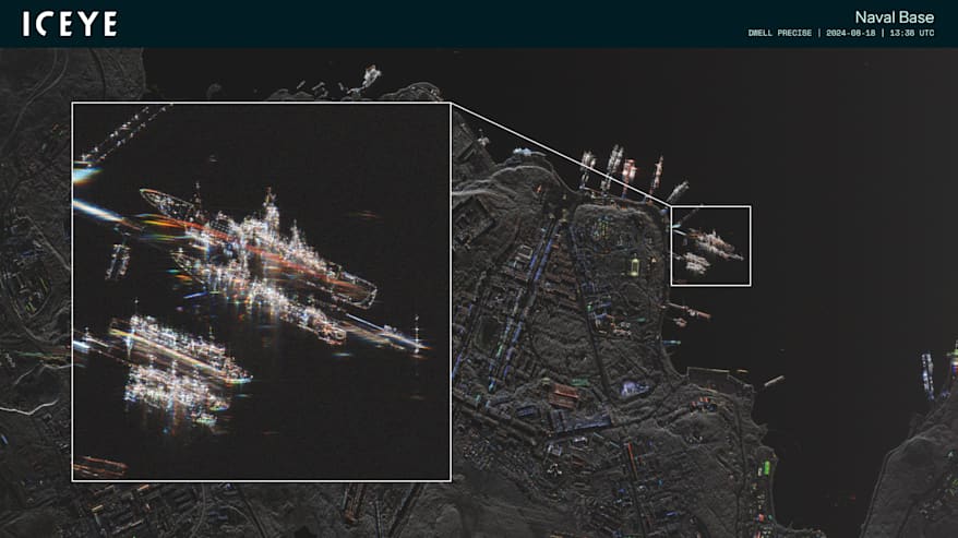 Tarkka satelliittikuva, jossa näkyy satama-alue ja laivoja, yhdessä laiturissa olevat laivat näkyvät suurennetussa pikkukuvassa.