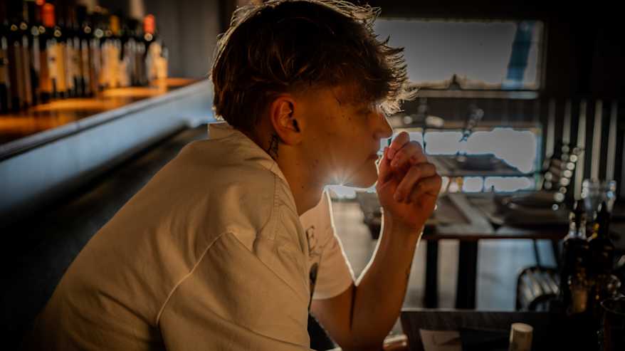 Miikka Muurinen istuu ravintolassa hammastikku suussa.