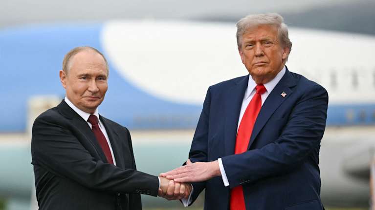 Trump och Putin håller i varandras händer.