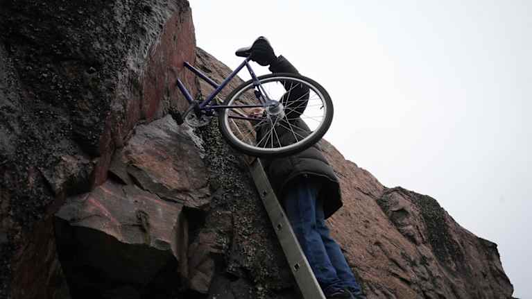 Markku Puustinen fiksaamassa Pyöräilijä-teostaan. 
