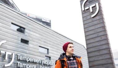 Iñigo Flores Ituarte standing in front of the Tampere University main building in Hervanta.