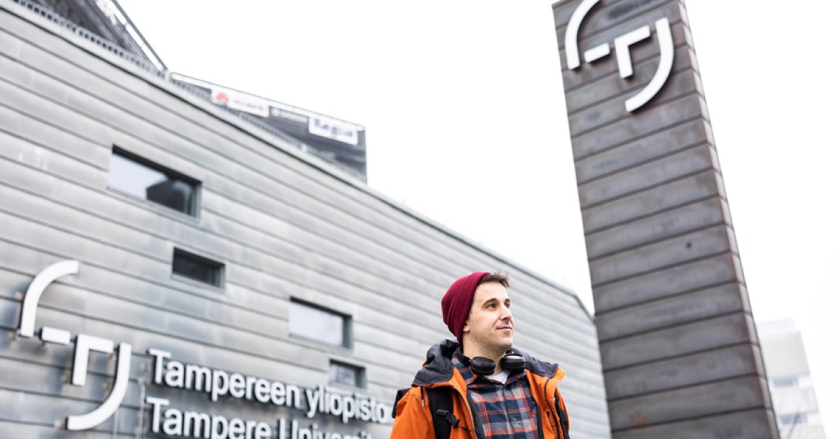 Iñigo Flores Ituarte standing in front of the Tampere University main building in Hervanta.