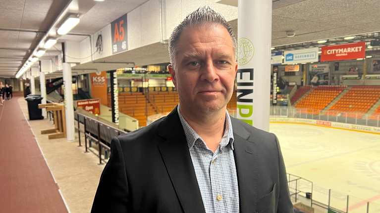 Mies seisoo jäähallin ylätasanteella.