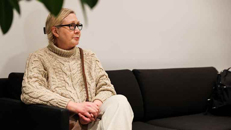 Anneli Auer istuu oikeustalon penkillä Turussa.