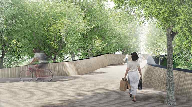 Havainnekuva sillasta. Vaaleapuinen silta kiemurtelee hieman puiden keskellä.