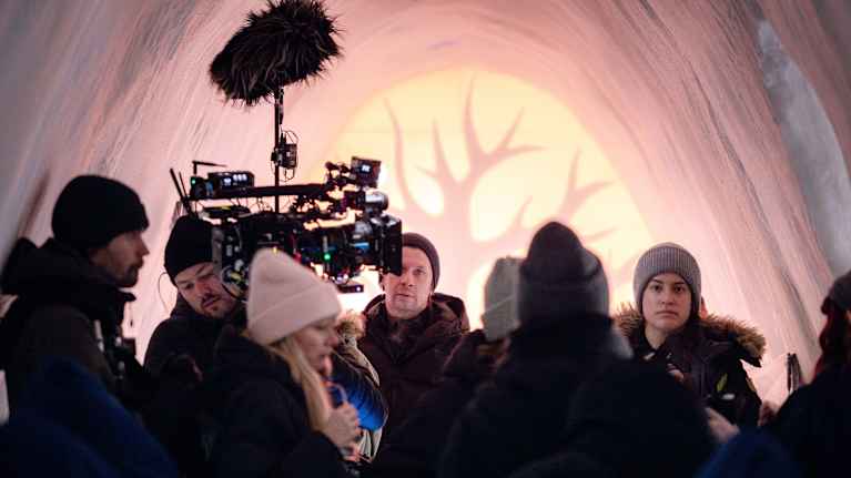 Talvivaatteisiin pukeutunut ihmisryhmä elokuvan kuvauksissa.