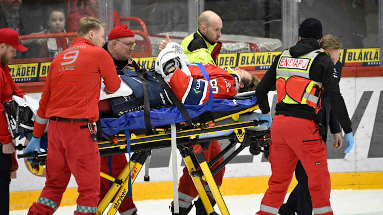 HIFK:s målvakt Hugo Alnefelt bärs ut på bår efter att ha kolliderat med en spelare.