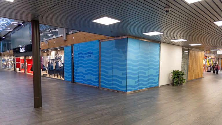 Sinisillä kankailla peitetty tyhjä liiketila kauppakeskus Pasaatissa.