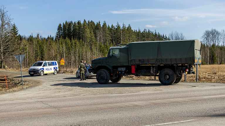 Puolustusvoimien sotilasajoneuvo sekä poliisiauto Kouvolassa.