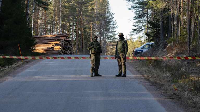 Kaksi sotilasta vartioimassa tiesulkua Väliväyläntiellä Luumäellä. Tiesulun takana olevalle metsäalueelle putosi ukrainalainen taisteludrooni 29.3.2026.
