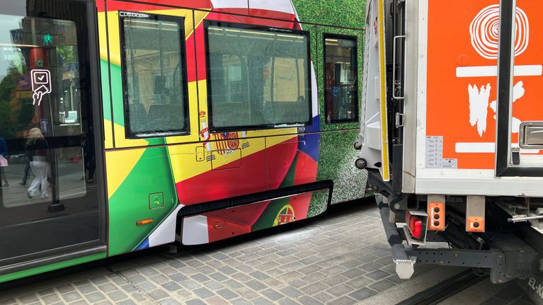 Raitiovaunu ja K-kaupan kuorma-auto pysähtyneinä risteyksessä.
