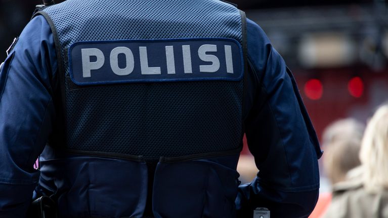 Poliisin selkä ja univormu Suomi-areenassa.