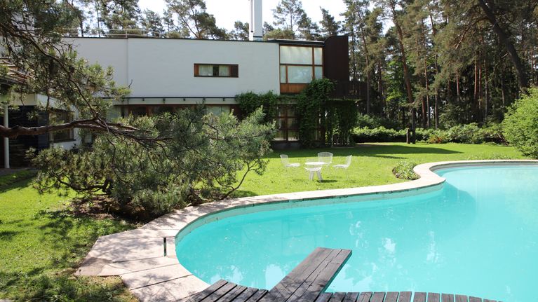 Villa Mairean sisäpiha, etualalla uima-allas ja takana rakennus.