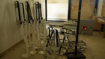 Erilaisia sairaanhoidollisia apuvälineitä entisen kehitysvammaisten kuntoutuskeskuksen tiloissa. 