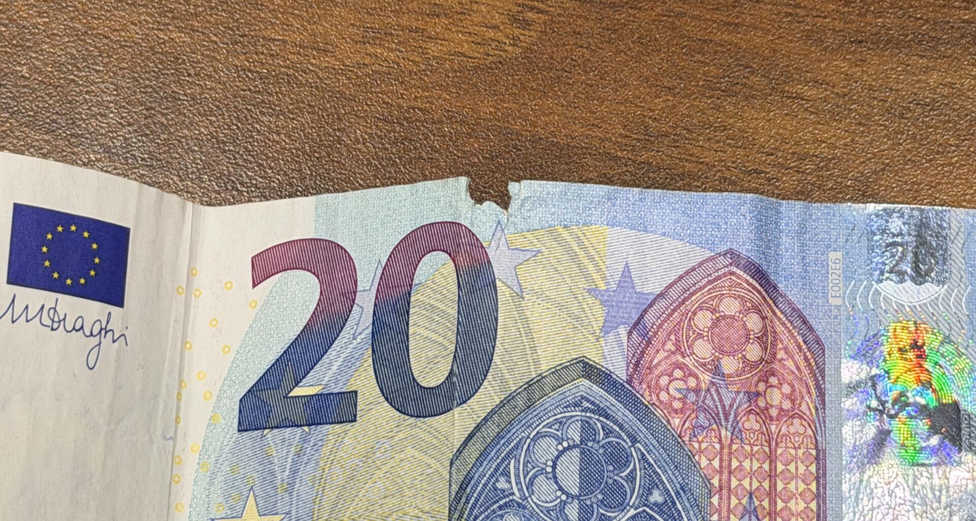 The central W-shaped damage of the euro