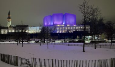 Finlandia Hall with evening lighting (and the tower of National Museum behind.)
