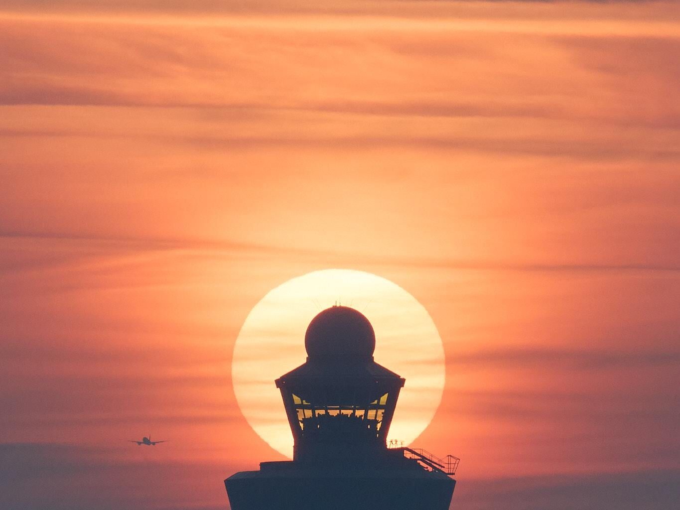 Setting sun behind the Schiphol air traffic tower