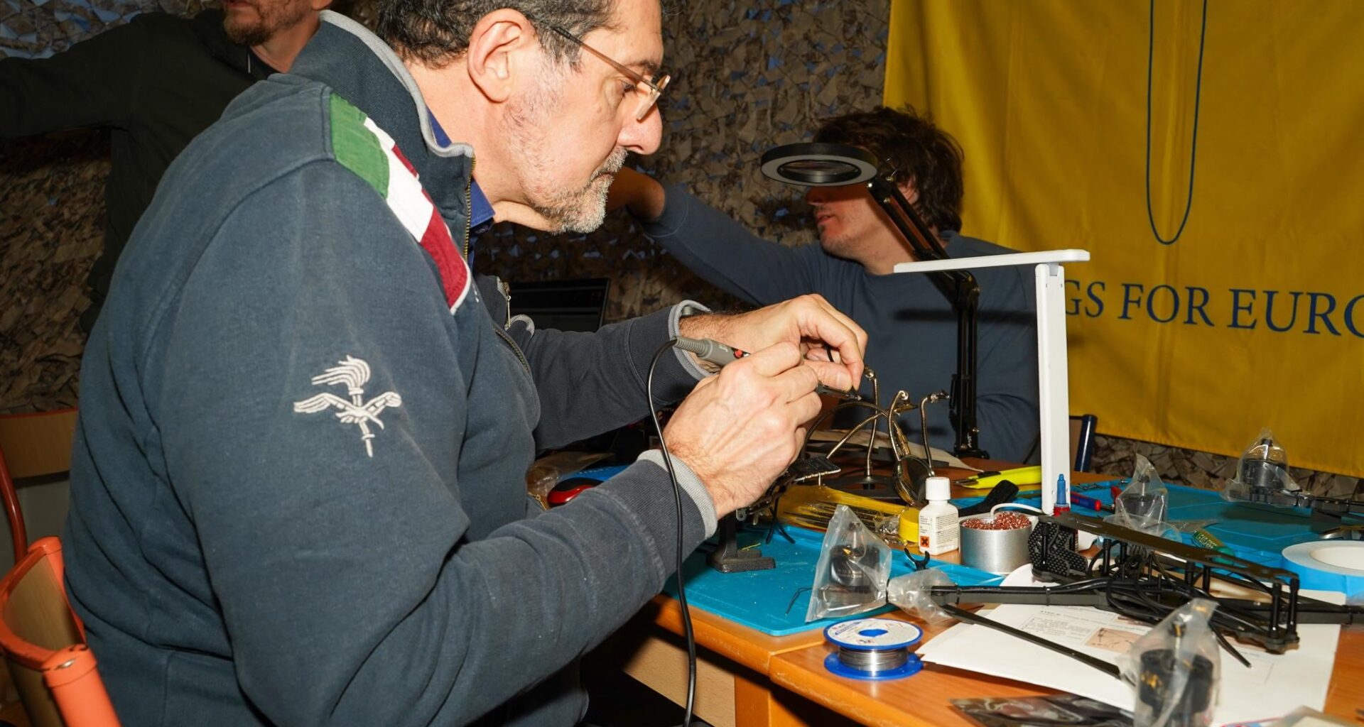In a secret location in Brussels, ordinary people are aiding the war effort. They're assembling drones assisted by Wings for Europe