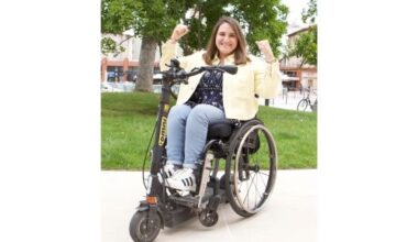 Charlotte Alaux sur sa trottinette Omni, levant les coudes en signe de victoire.