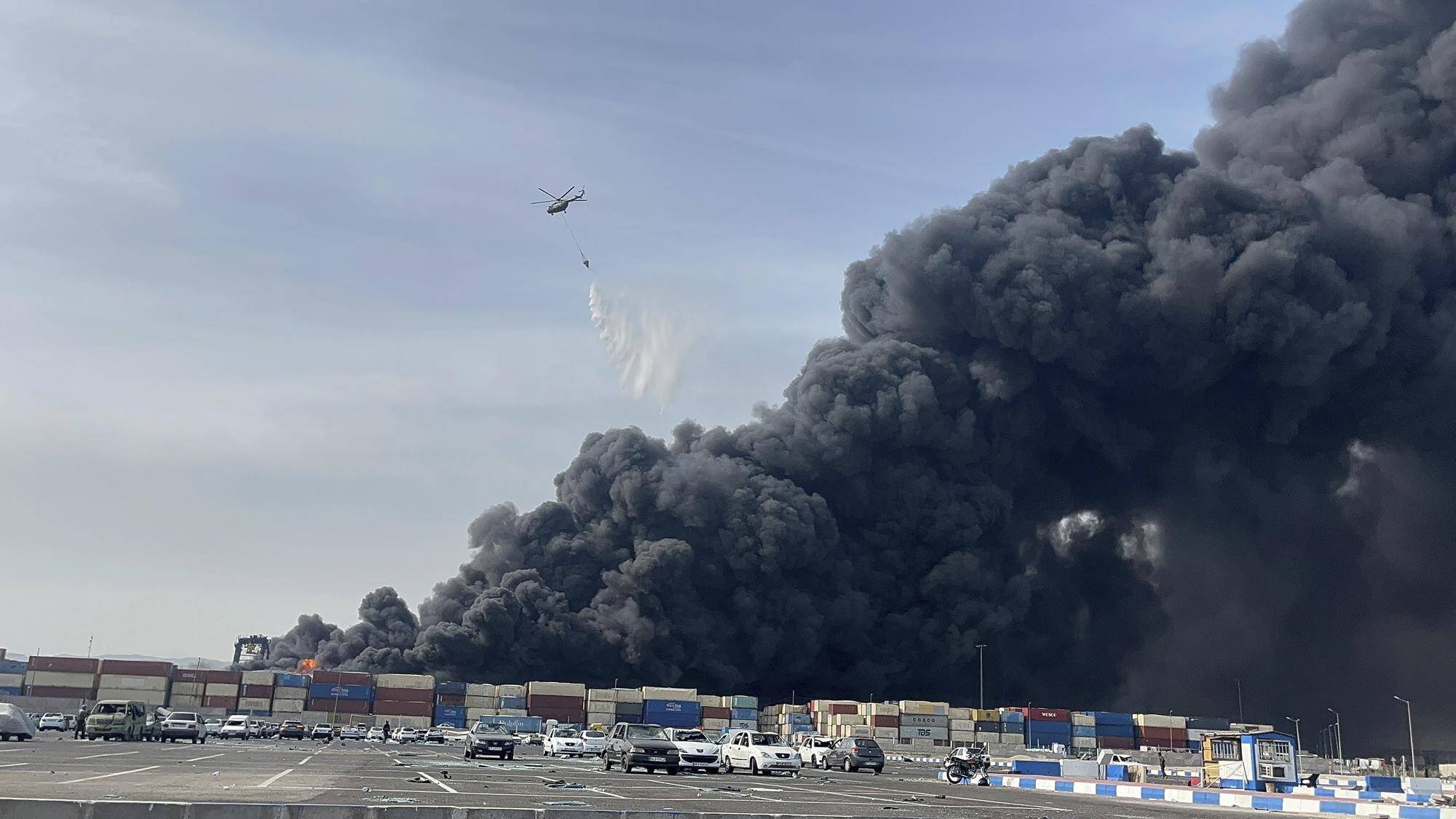 Sur cette photo fournie par l'Agence de presse des étudiants iraniens, ISNA, un hélicoptère largue de l'eau sur le feu après une explosion massive qui a secoué un port près de la ville portuaire méridionale de Bandar Abbas, en Iran, le samedi 26 avril 2025. — © Razieh Pudat / keystone-sda.ch