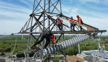 Des apprentis suivent une formation sur un pylône au centre de formation de National Grid à Eakring, dans le centre de l'Angleterre, le 28 avril 2025, perchés à 45 mètres de hauteur © AFP Darren Staples
