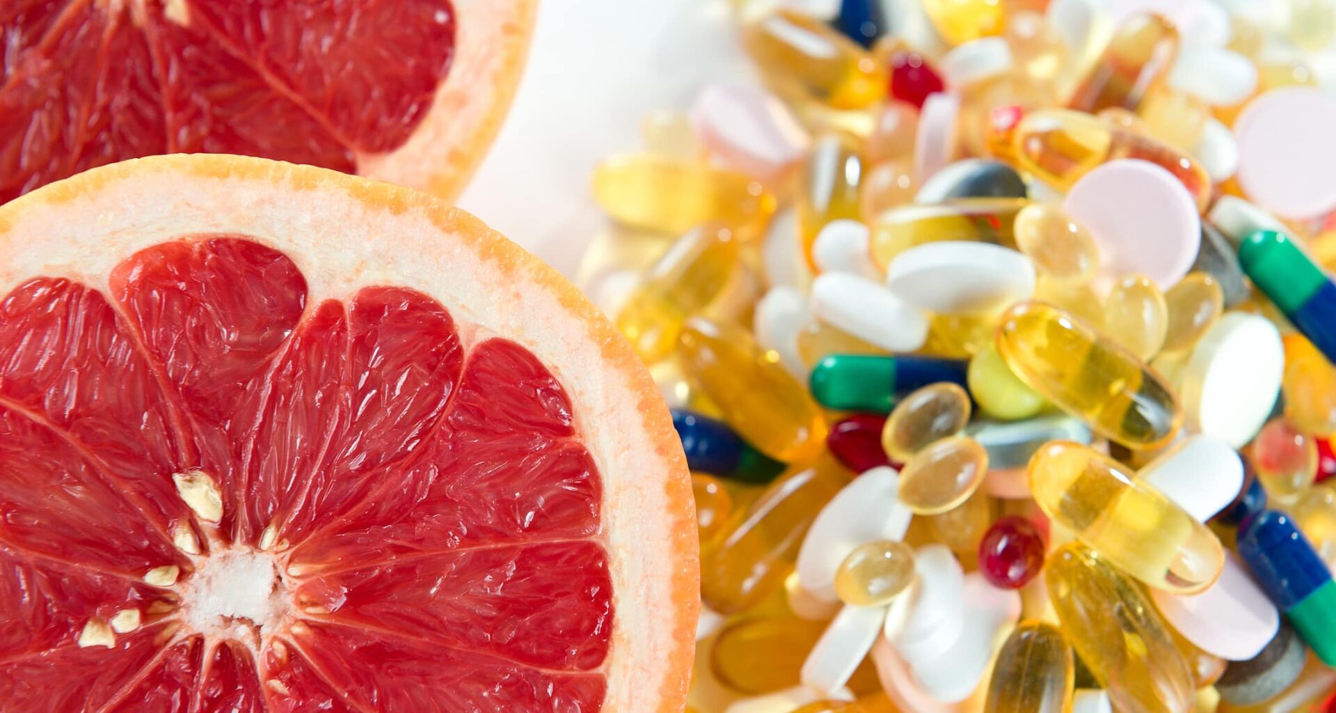 Pink Grapefruit And Pills, Vitamin Supplements On White Background