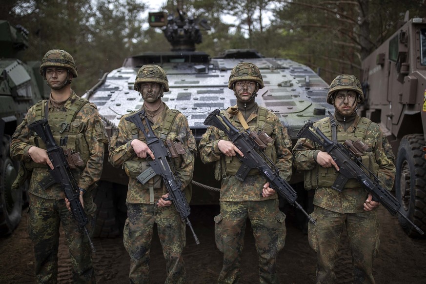 German Bundeswehr soldiers waits to greet German Chancellor Olaf Scholz upon his arrival at the Training Range in Pabrade, some 60km.(38 miles) north of the capital Vilnius, Lithuania, Monday, May 6,  ...
