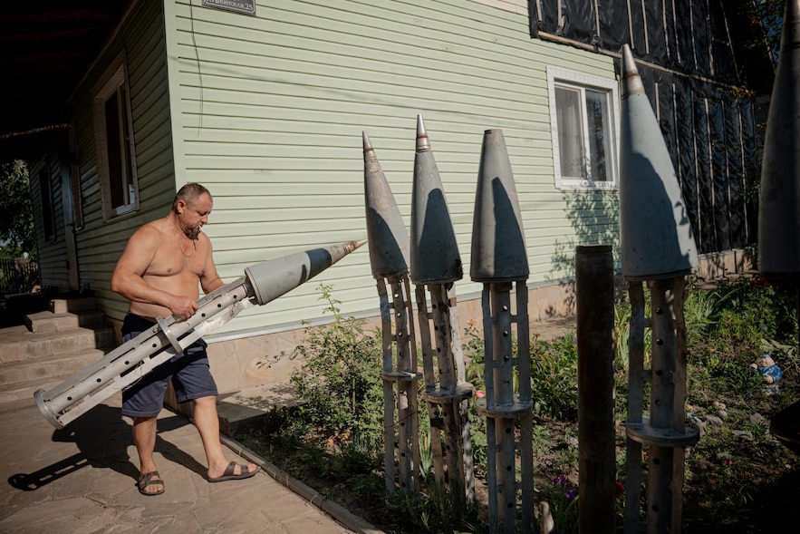 Un agriculteur ukrainien, Petro Pylypaka, transporte des parties de missiles russes dans la cour de sa maison dans le village de Ruski Tyshky (région de Kharkiv), le 15 juillet 2025.