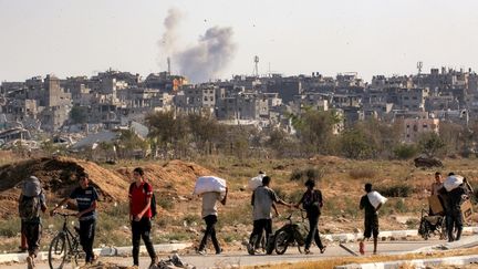 Des Palestiniens transportent de l'aide humanitaire, le 22 août 2025 dans la bande de Gaza. (EYAD BABA / AFP)
