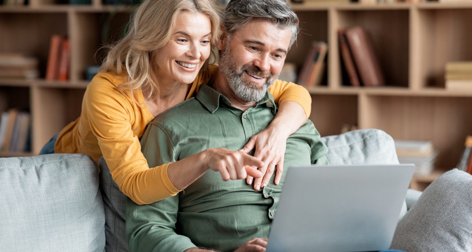 Happy Middle Aged Couple With Laptop Ordering Things From Internet Together