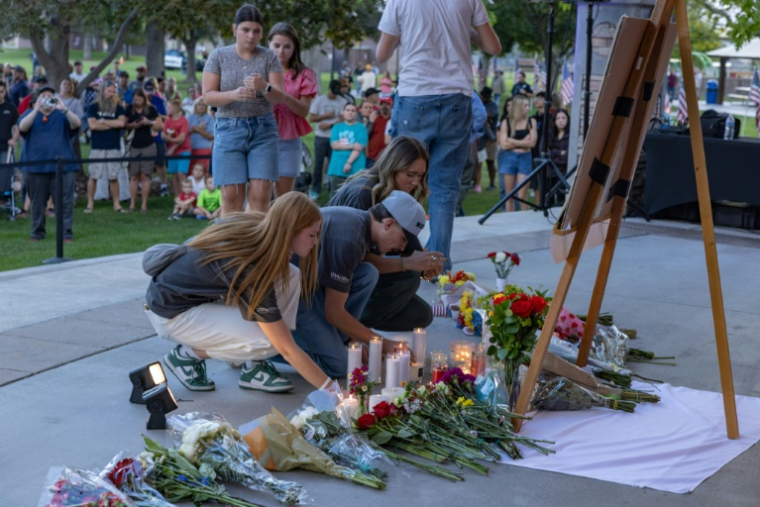 Des personnes déposent des fleurs en hommage à l'influenceur conservateur Charlie Kirk lors d'une veillée dans un mémorial improvisé à Orem, le 11 septembre 2025 dans l'Utah ( AFP / Melissa MAJCHRZAK )