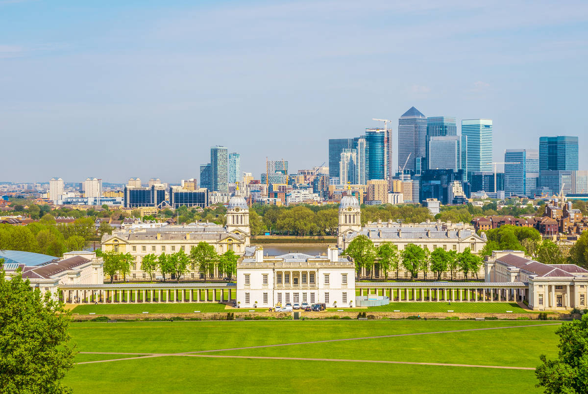 View of Queens House and Canary Wharf from Greenwich Park in London, England, UK