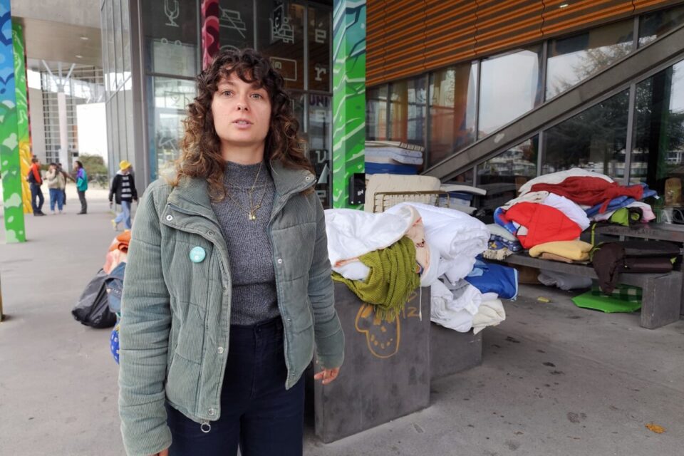 Suzanne Mamet, devant les tas de matelas rangés, qui servent aux migrants à la rue.