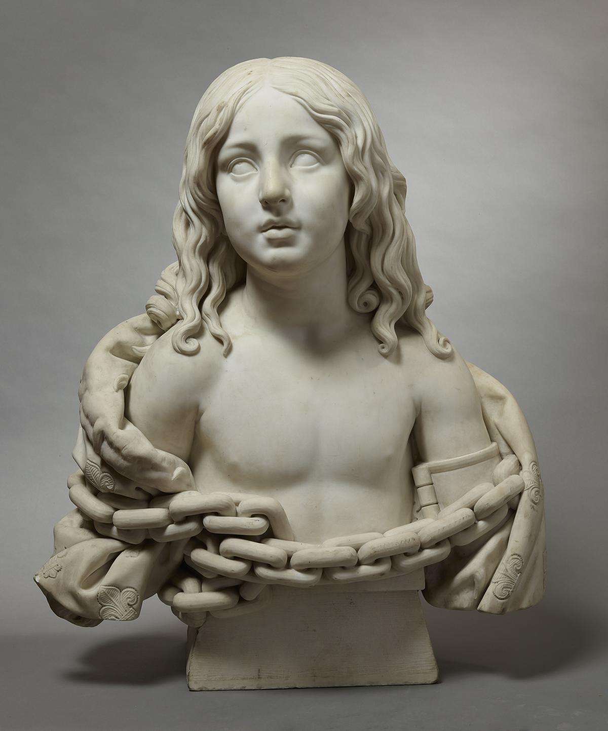 « Louis XVII enchaîné », le deuxième fils de Louis XVI et de Marie-Antoinette. Emprisonné avec sa famille à la tour du Temple, il est reconnu titulaire de la couronne suite au décès de son père en 1793 et meurt, seul, en captivité à l’âge de 10 ans