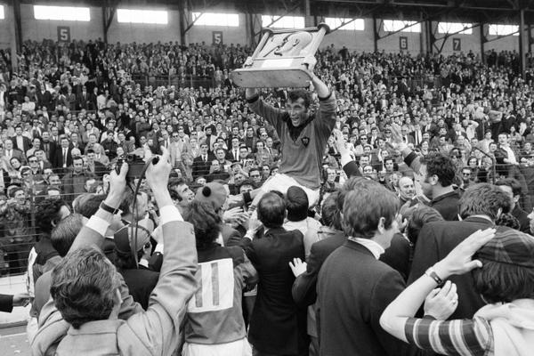(FILES) RC Toulon rugby player Andre Herrero holds the trophy and celebrates with supporters their victory over SU Agen at the Challenge Yves du Manoir, on May 24, 1970 in Colombes. André Herrero, "the great one," former French national rugby union team player but above all an emblematic figure of RC Toulon, where he served as a player, coach, and president, passed away during overnight on October 24, 2025 at the age of 87, the club from the Var region announced in a statement. (Photo by AFP)