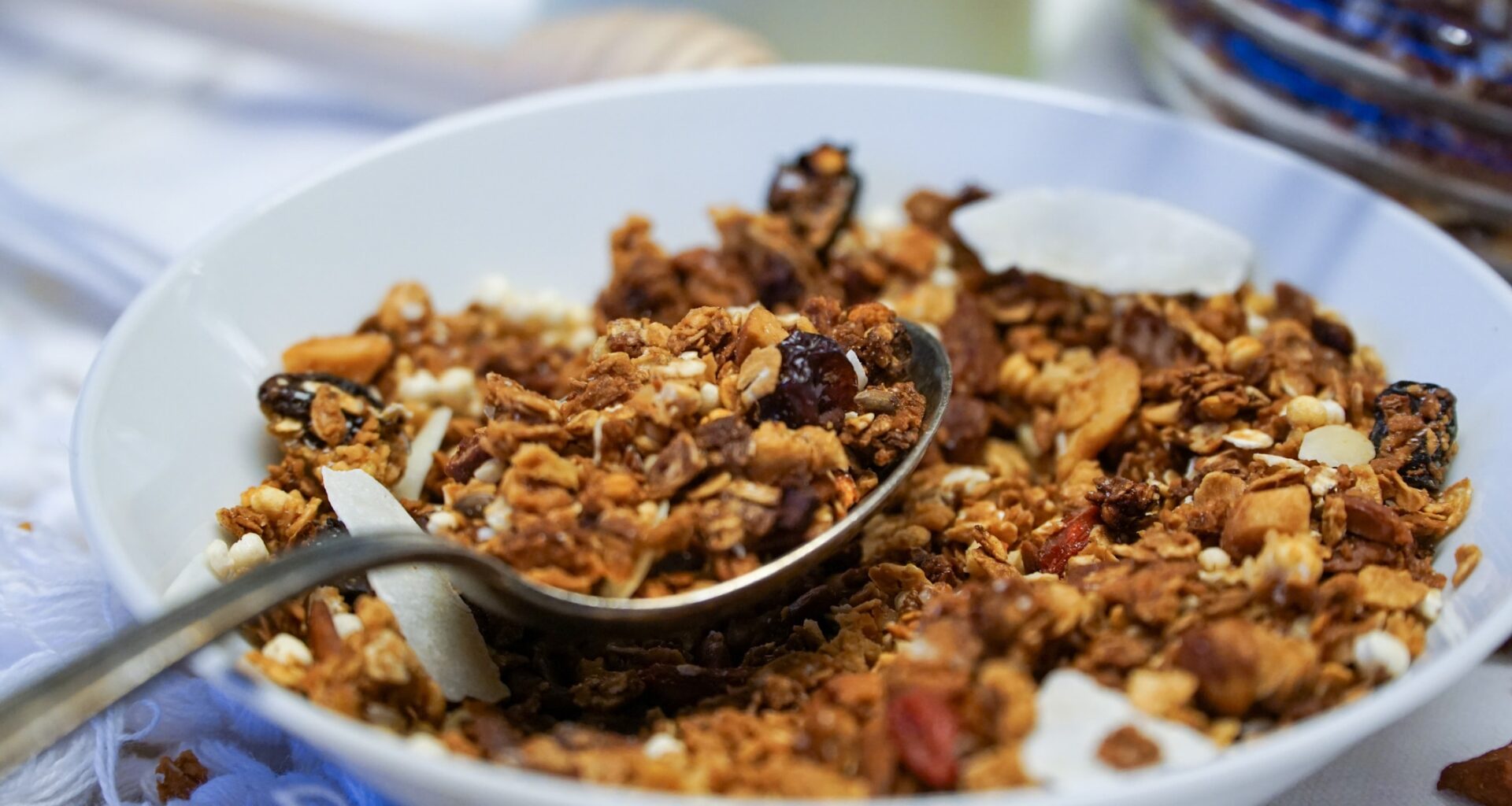 A Close Up Vigranola noix santéew Of A Bowl Filled With Granola, Displaying Its Wholesome Blend Of Oats, Nuts, Seeds, And Dried Fruits, Ready To Be Savored For A Delightful And Nutritious Meal.