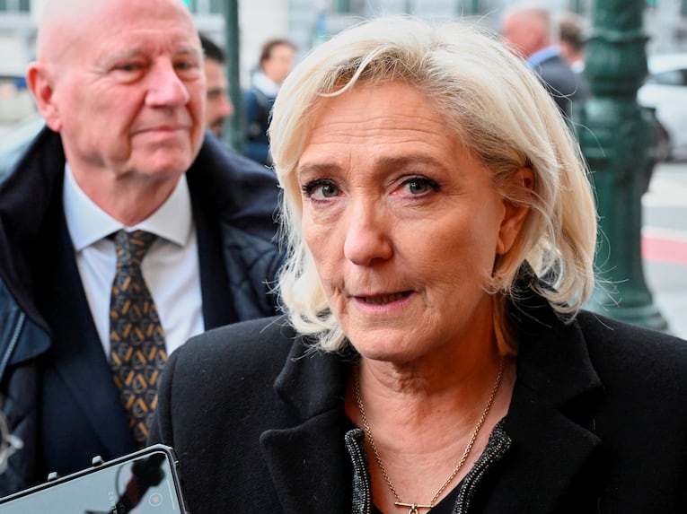 French far-right leader Marine Le Pen speaks with the media as she arrives for the Patriots for Europe group leaders meeting ahead of an EU leaders summit in Brussels, Wednesday, Dec. 17, 2025. (AP Photo/Harry Nakos)/VLM108/25351472911223//2512171415