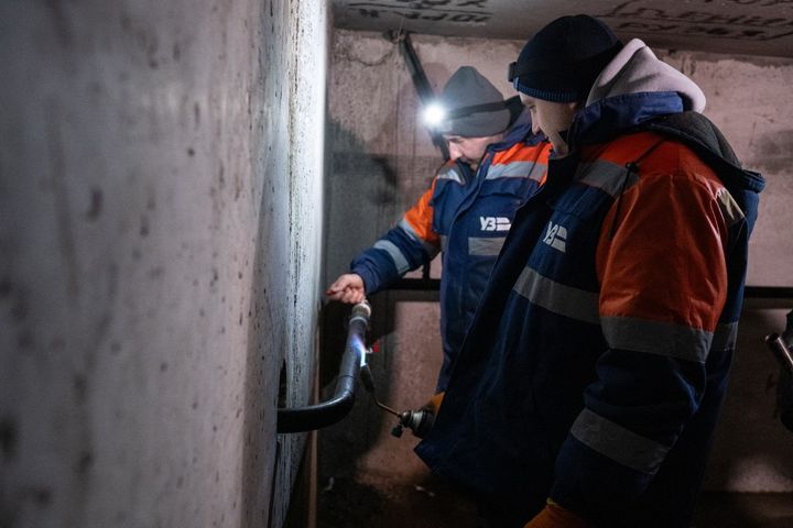 Des employés travaillent à rétablir l'eau chaude dans un immeuble résidentiel de Kiev, en Ukraine, le 21 janvier 2026. (DANYLO ANTONIUK / NURPHOTO / AFP)
