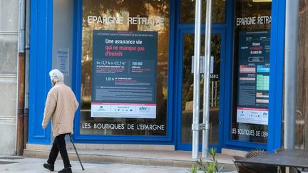 Une personne âgée passe devant la vitrine d'une compagnie d'assurance, à Valence (Drôme), 10 novembre 2020. (Nicolas Guyonnet / Hans Lucas / AFP)