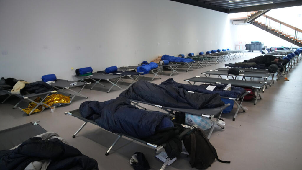 Des sans-abri dorment dans un refuge installé par la Croix-Rouge dans le Grand Palais, à Paris, le 7 janvier 2026, en pleine vague de froid.