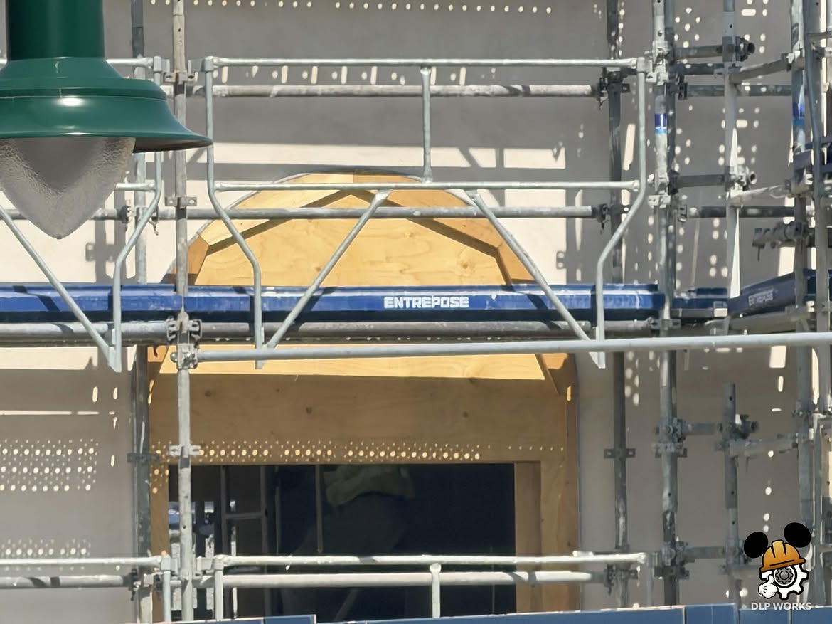 Themed architectural elements are being added to the building for the ride's technical facilities. There are now columns, archways, and overhangs. Wooden frames act as molds while concrete hardens.