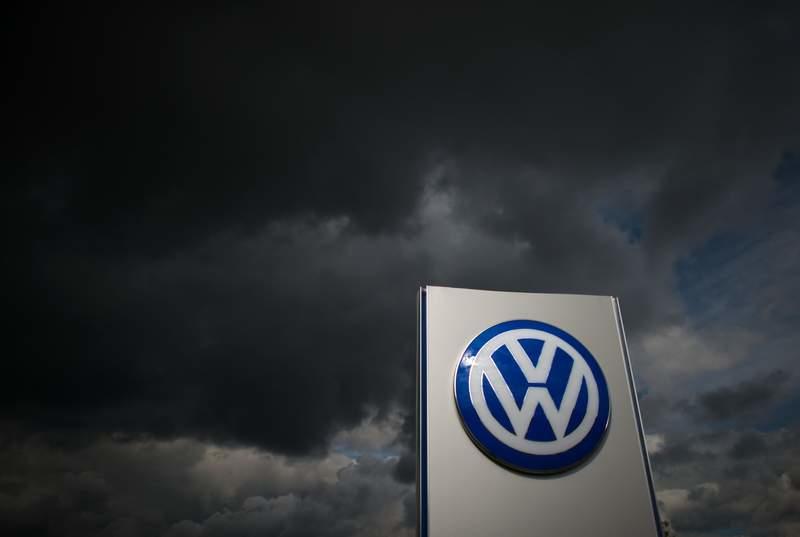 FILE PHOTO - Dark clouds pass over a Volkswagen logo at the Sandkamp gate of the VW plant in Wolfsburg. (zu dpa: «Union and employees insist on no VW plant closures in Germany») Julian Stratenschulte/dpa