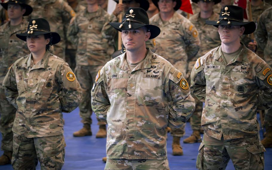 Soldiers stand in formation.