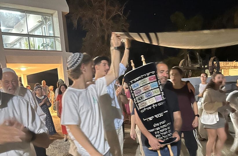 Marching and singing with the Torah scroll at the dedication ceremony in Kibbutz Nahal Oz.