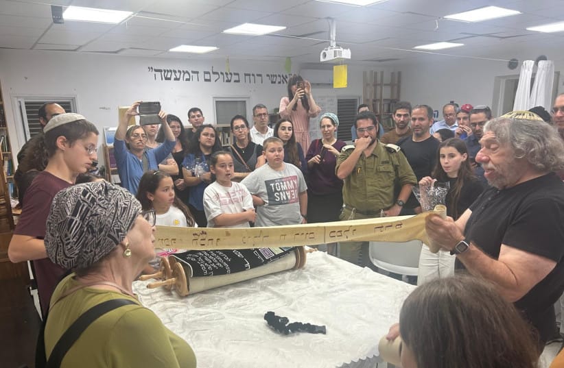 The writer (R) with the outstretched ‘wimpel’ probably used to tie the Torah scroll at his father’s bar mitzvah in Germany almost a century ago.