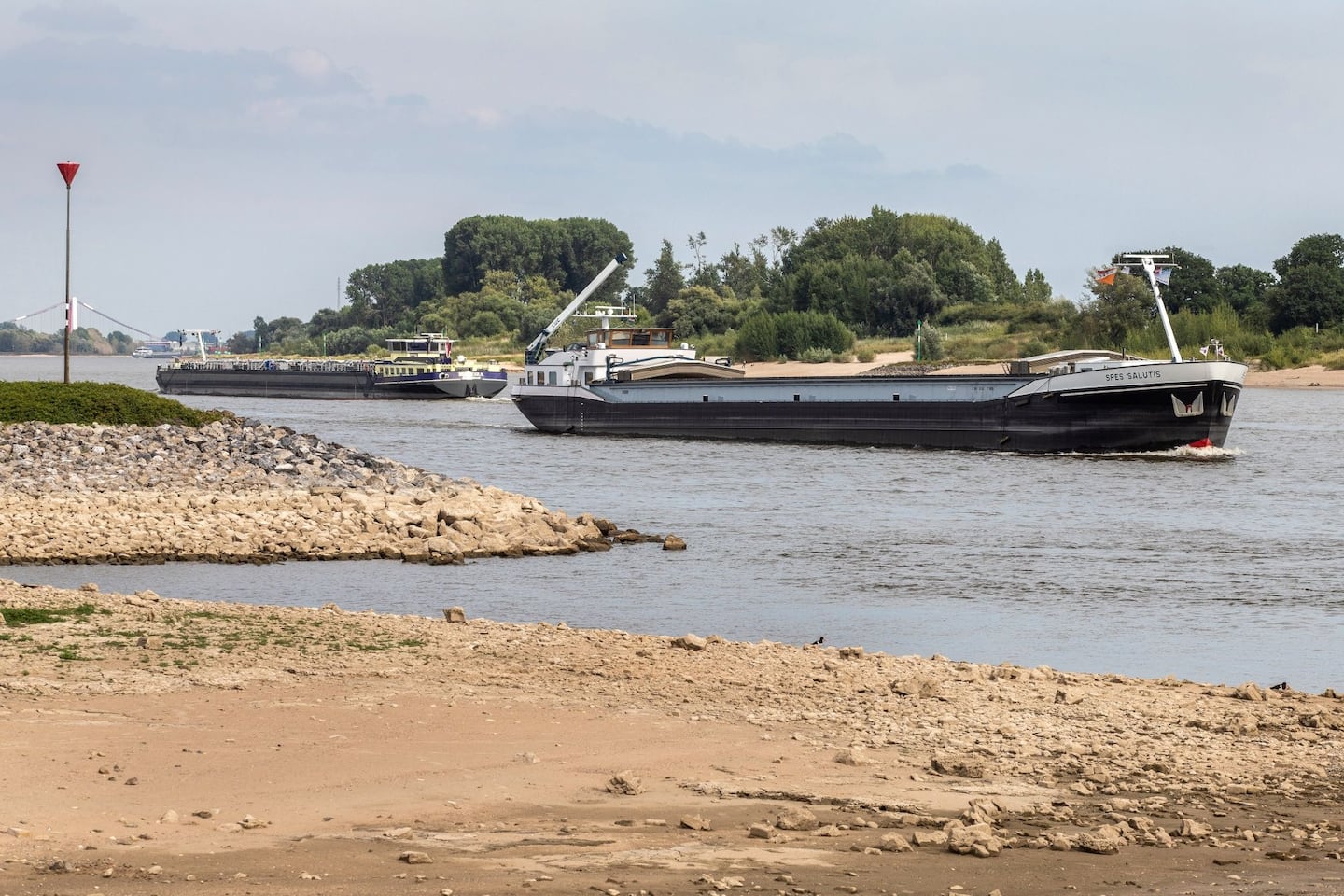 Half-loaded barges passed each other closely in low waters caused by drought on the Rhine River in Lobith, Netherlands, in July.