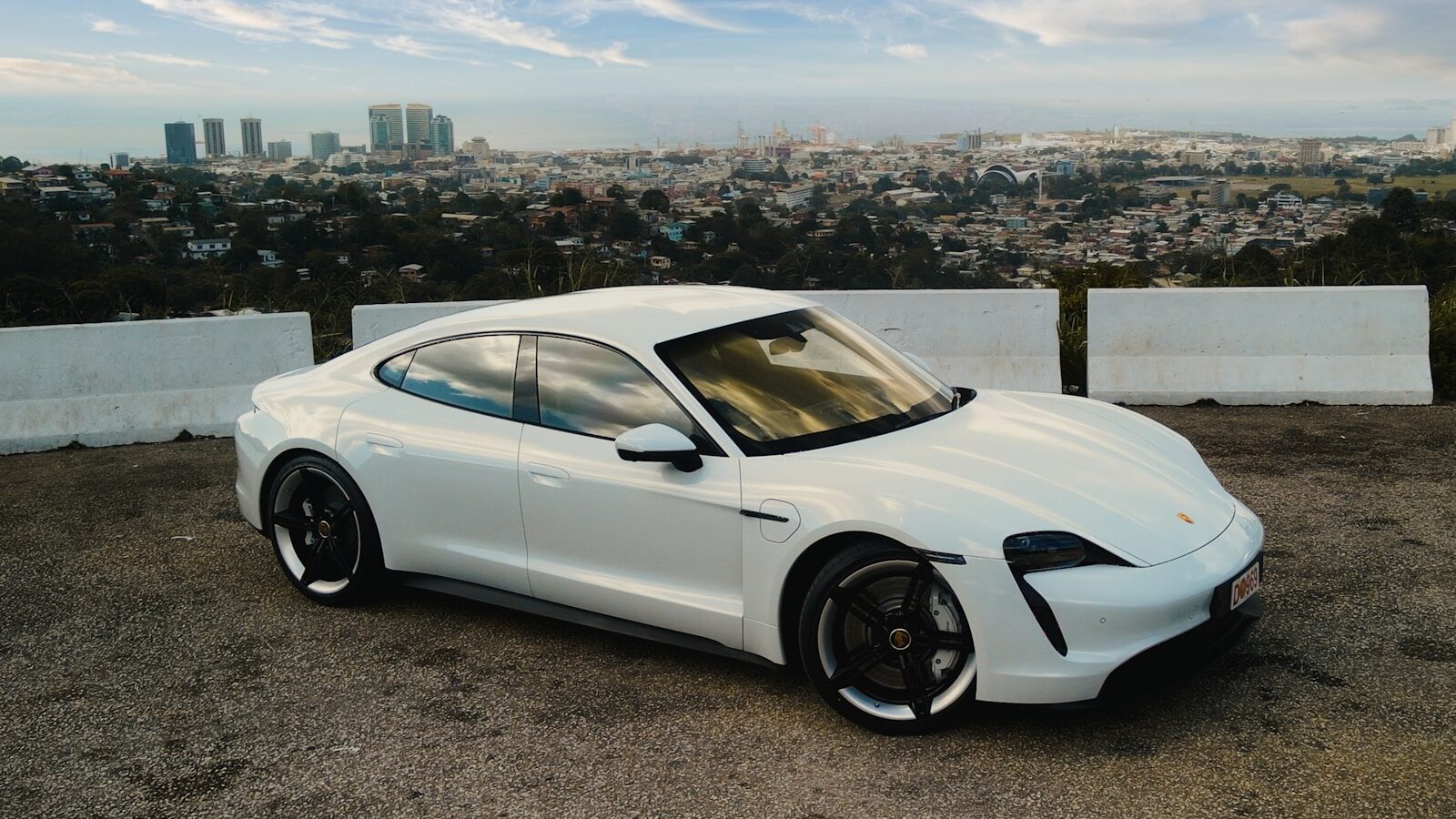 a white sports car parked in a parking lot