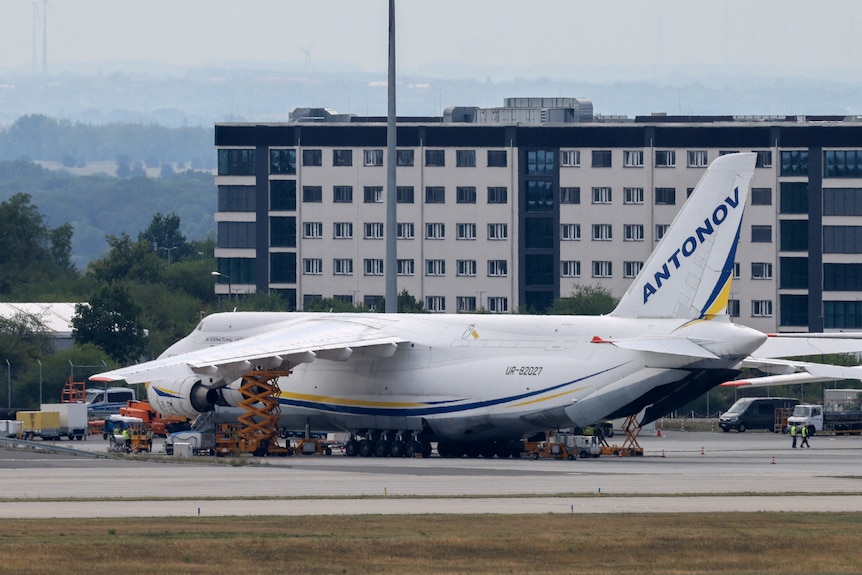 A large four-engine Antonov cargo plane sitting on a runway.